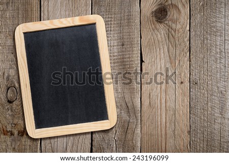 Blank blackboard on old wooden background