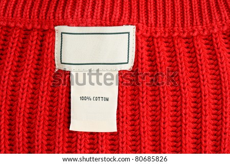 Clothing label inside of red sweater