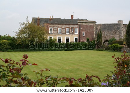view of english country home with lawn