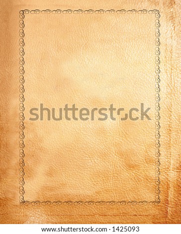 close up of a tan leather bound book