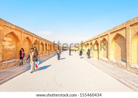 ISFAHAN, IRAN - DECEMBER 31: People walking along the Si-o-se Pol in Isfahan, Iran on December 31, 2012. It was built in 1602 is 298m long and 14m wide.