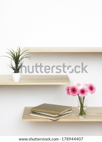 pink flowers on book shelf