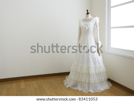 Wedding dress in white room.