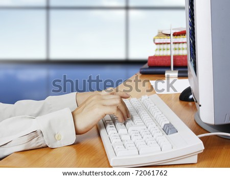 Hand touching computer keys during work