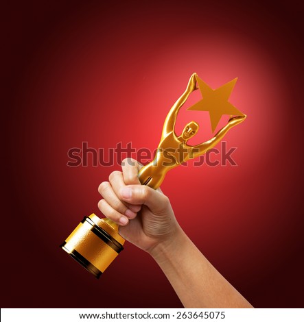 Star award in hand on red background.
