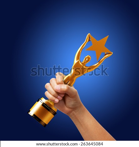 Star award in hand on blue background.