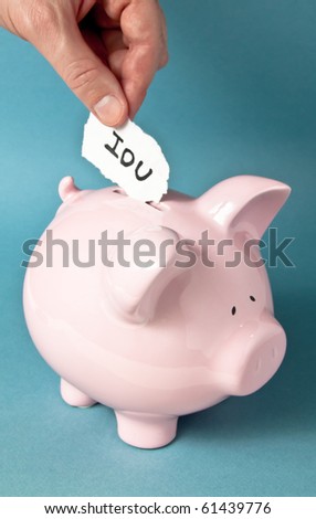 A close up of pink piggy bank on a blue background with a hand placing an IUO paper note into the bank