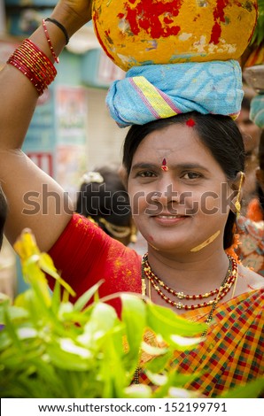 HYDERABAD, INDIA - JULY 28: Unidentified Hindu lady carries decorated pots of offerings and visit Kali temple to celebrate the famous Bonalu festival on 28 July 2013.