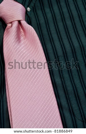 pink necktie tied on black pinstriped shirt