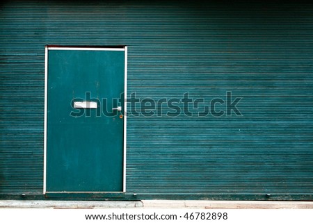 Simple green metallic doors with striped wall