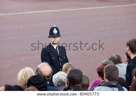 LONDON - JUNE 11: British police observe crowd of spectators during Trooping the Color ceremony, London, June 11, 2011. Ceremony is performed by regiments on occasion of the Queen\'s Official Birthday