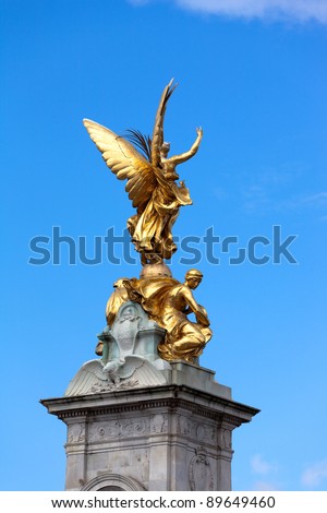 Gilded statue of Goddess of Victory on pinnacle of Queen Victoria Memorial. It\'s located right in front of Buckingham Palace, London.