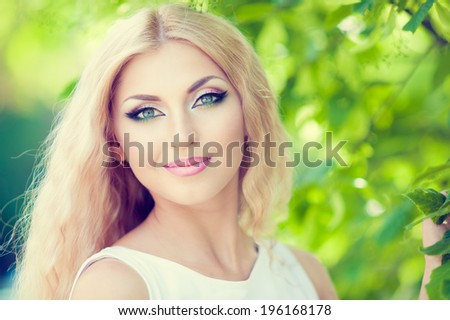 beautiful woman with bright makeup and blonde long hair