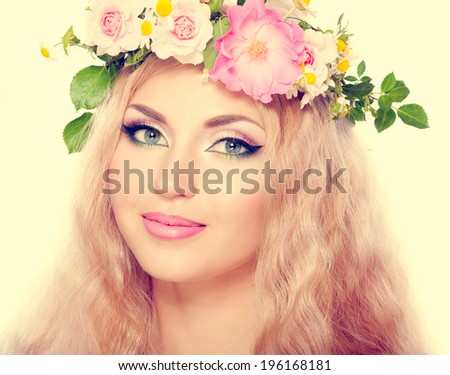 beautiful woman with bright makeup and blonde long hair, with flowers