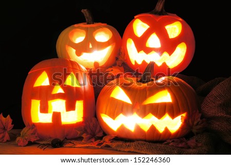 Group of Halloween Jack o Lanterns lit up in the dark