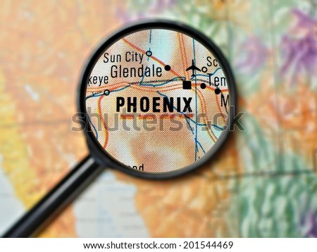 Close up of Phoenix, Arizona under a magnifying glass on a map