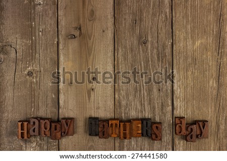 Happy Fathers Day vintage wood letters on a rustic wooden background