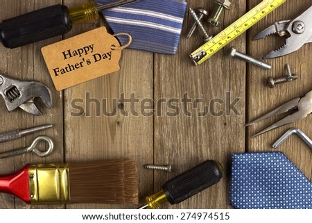 Happy Fathers Day gift tag with frame of tools and ties on a rustic wood background