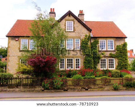 English style brick house with colorful front garden