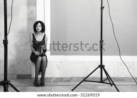 Fashion portrait of young attractive lady in palace. Black and white photo