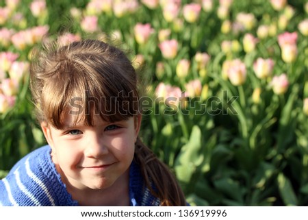 little girl on the walk in the spring park