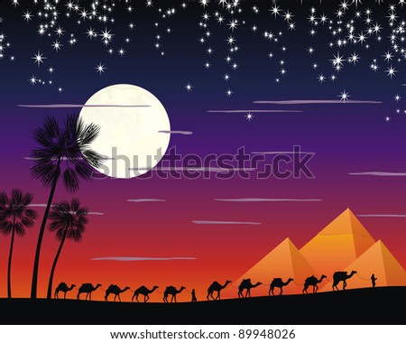 caravan of camels in the desert near the pyramides under the moon