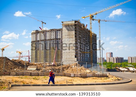 The construction site. Construction of the new building. Construction cranes.