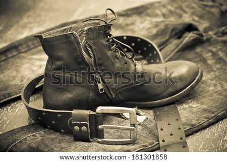 Leather shoes, leather belt, jeans. Cowboy style. Vintage style. Black and white photo
