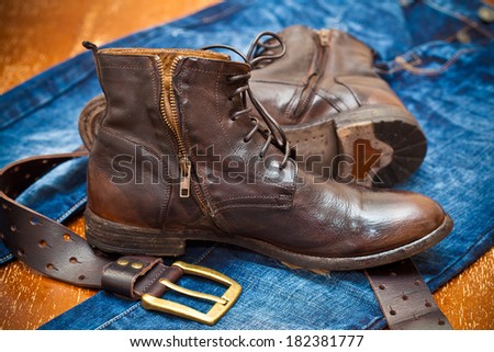 leather shoes, leather belt with a gold buckle, jeans. Cowboy style. Vintage.