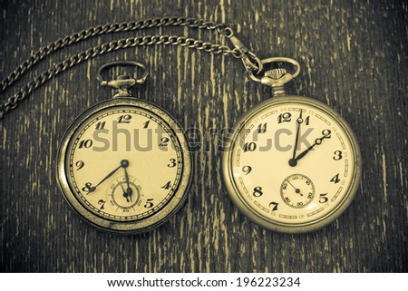 Vintage watch with chain on vintage background