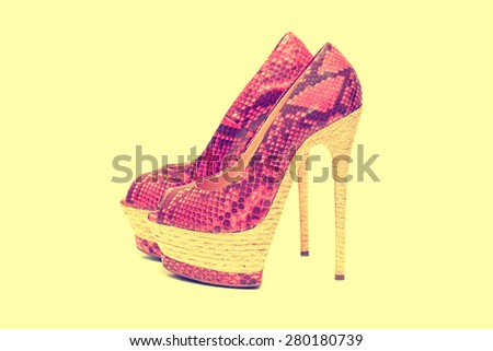 women\'s leather shoes with heels pink isolated on a yellow background