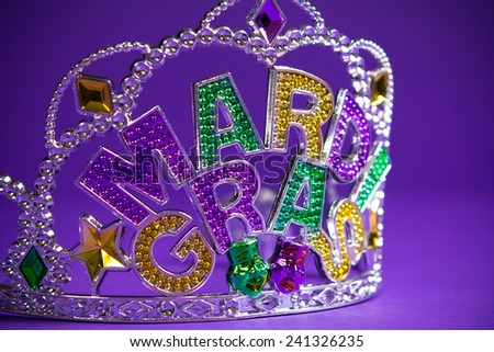 A colorful mardi gras crown on a purple background
