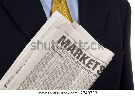 Business man carring newspaper open to the market and business sections