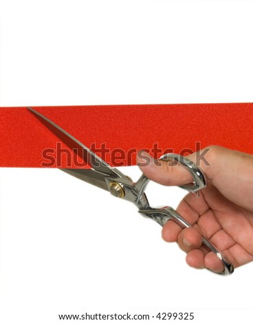 Closeup of a mans hand cutting a red ribbon with shiny scissors focus on ribbon