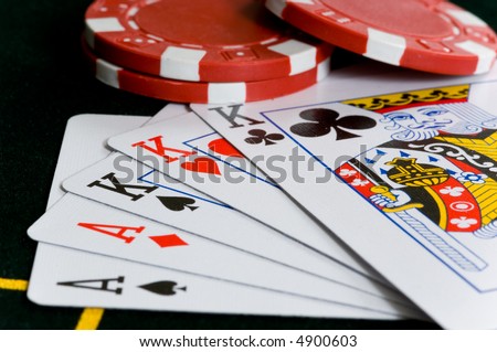 Poker Chips and hand of cards that makes a full house