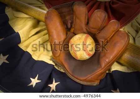 Antique baseball glove, ball and bat on vintage american flag inpired bunting