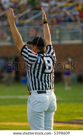 A Football Official signaling football and a game of American Football