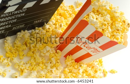 Movie and entertainment industry items, including a box of popcorn a movie clapboard and a strip of 35mm film