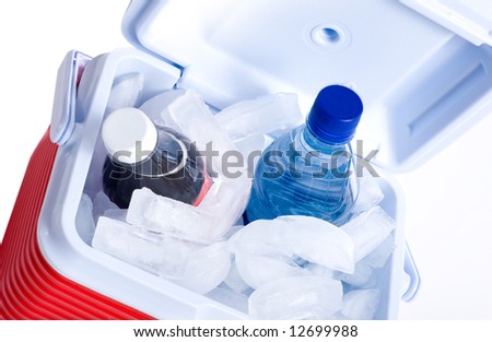 A small ice chest or cooler with drink including a cola and a bottle of water