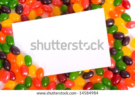 A white blank note-card surrounded by multi-color jelly beans,  Easter note-card or communication with copy space