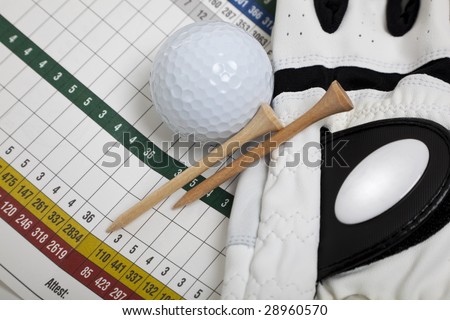 A blank golf scorecard with golf glove, tees and a golf ball.  Sports, golf concept