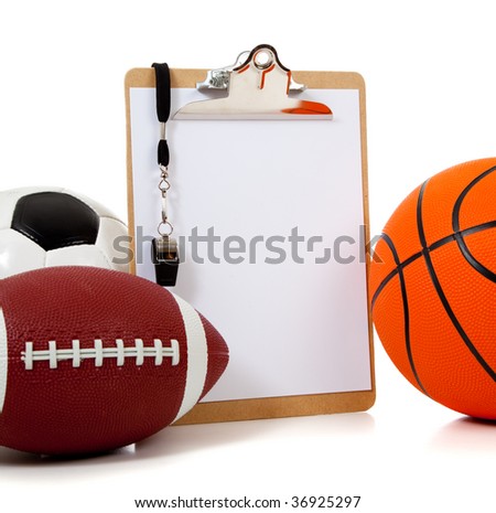A group of sports ball with a blank clipboard including a basketball an American football and a soccer ball on white