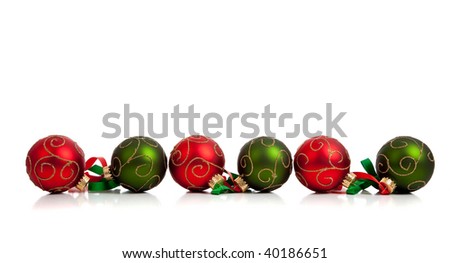 A christmas ornament border with red and green glittered baubles with red and green ribbon on a white background