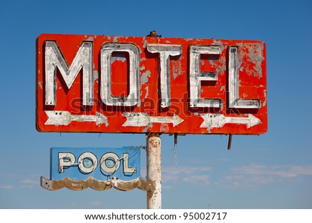 Red, vintage, neon motel sign on blue sky