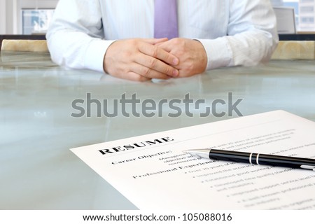Job Interview. Job interview in the office with focus on resume and pen
