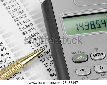 Tax calculator  and pen.  Pen and calculator with TAX button on the financial document