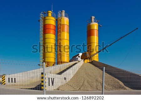 A concrete manufacturing plant with yellow tanks.