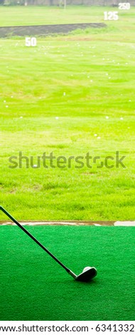 Ball and golf iron on the fake green grass in golf course