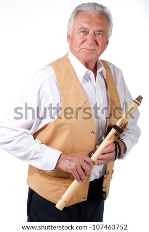 senior musician with native american flute and leather vest