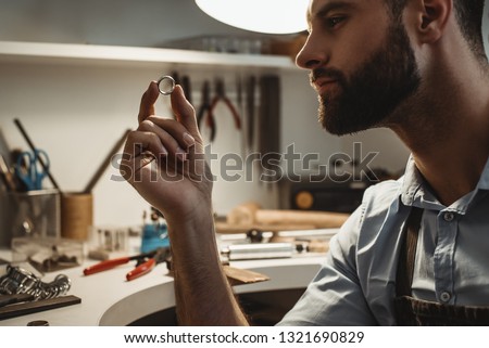 Similar – Image, Stock Photo Mature jeweler creating gold item using a pencil in workshop